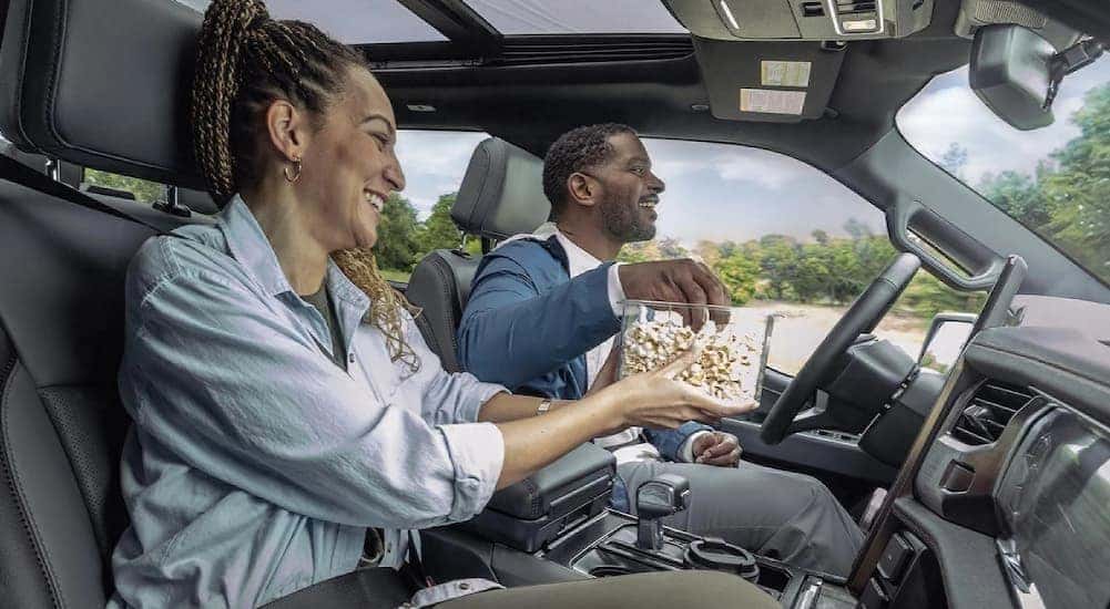 Two people riding in a 2025 Ford F-150 Lightning.