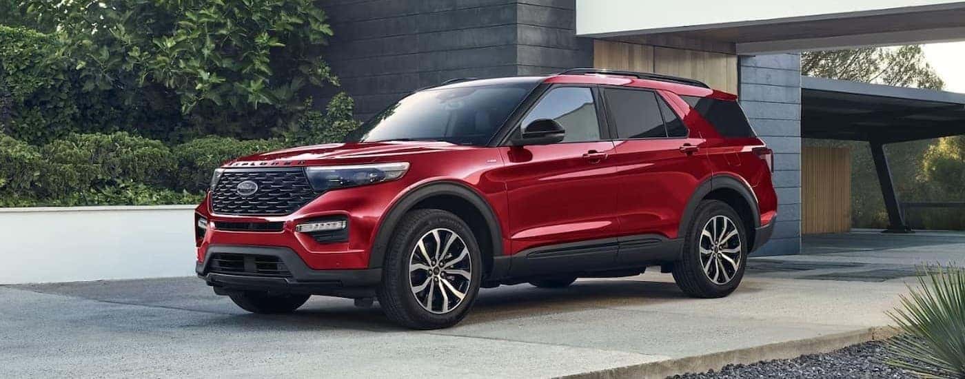 A red 2024 Ford Explorer parked on a driveway.