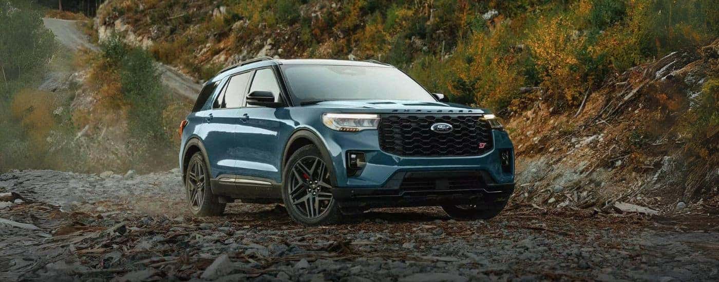 A blue 2025 Ford Explorer ST parked off-road for sale near Westcliffe