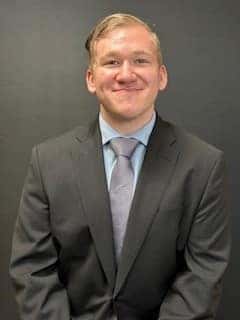 Purchasing agent Adrian Sheriff is shown.