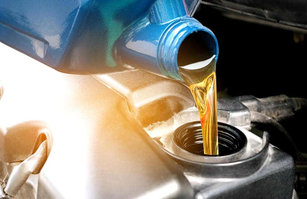 Technician performing a Ford oil change in Latham, NY