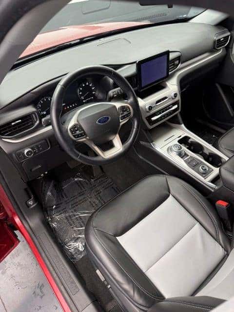 Interior of a used 2022 Ford Explorer with leather-trimmed seats and touchscreen display