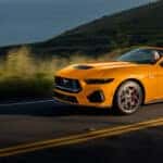 2026 Ford Mustang convertible driving along a scenic road near Muncie IN
