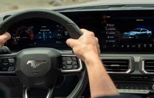 Driver view of 2026 Ford Mustang digital dashboard and steering wheel