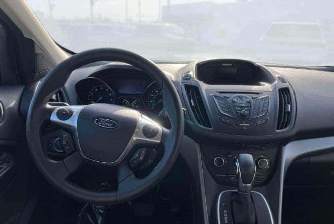 Used Ford SUV interior with steering wheel and dashboard features