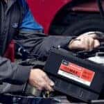 Ford technician performing winter battery inspection in Muncie IN