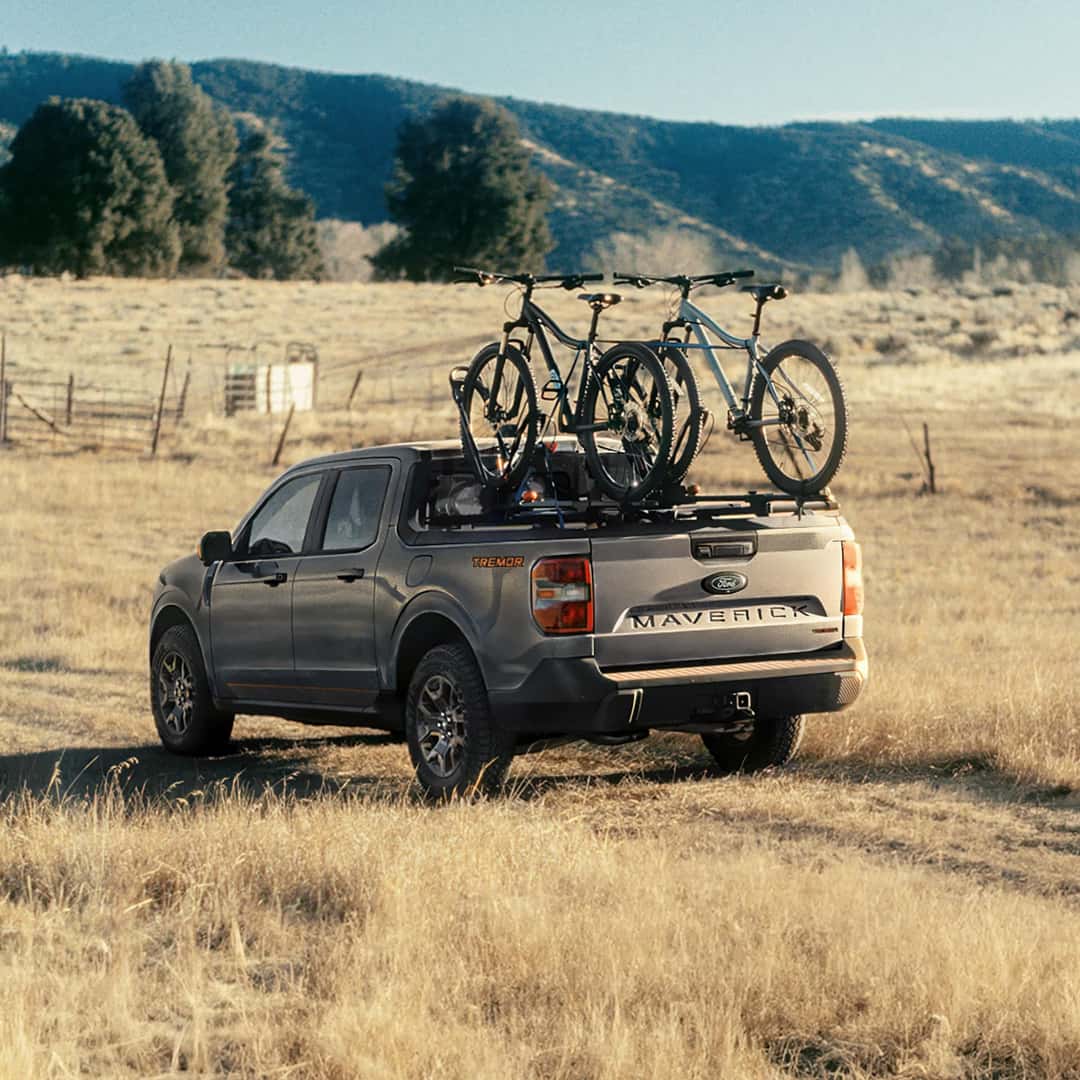 maverick tremor driving on a grassy area with bikes on the back of the truck