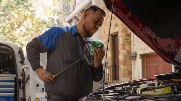 A service Team member performing a fluid check