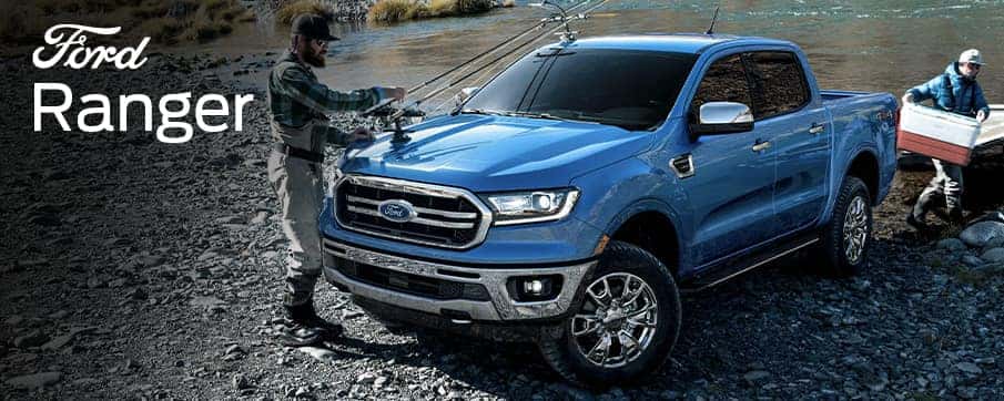 A blue Ford Ranger truck with fishing poles attached