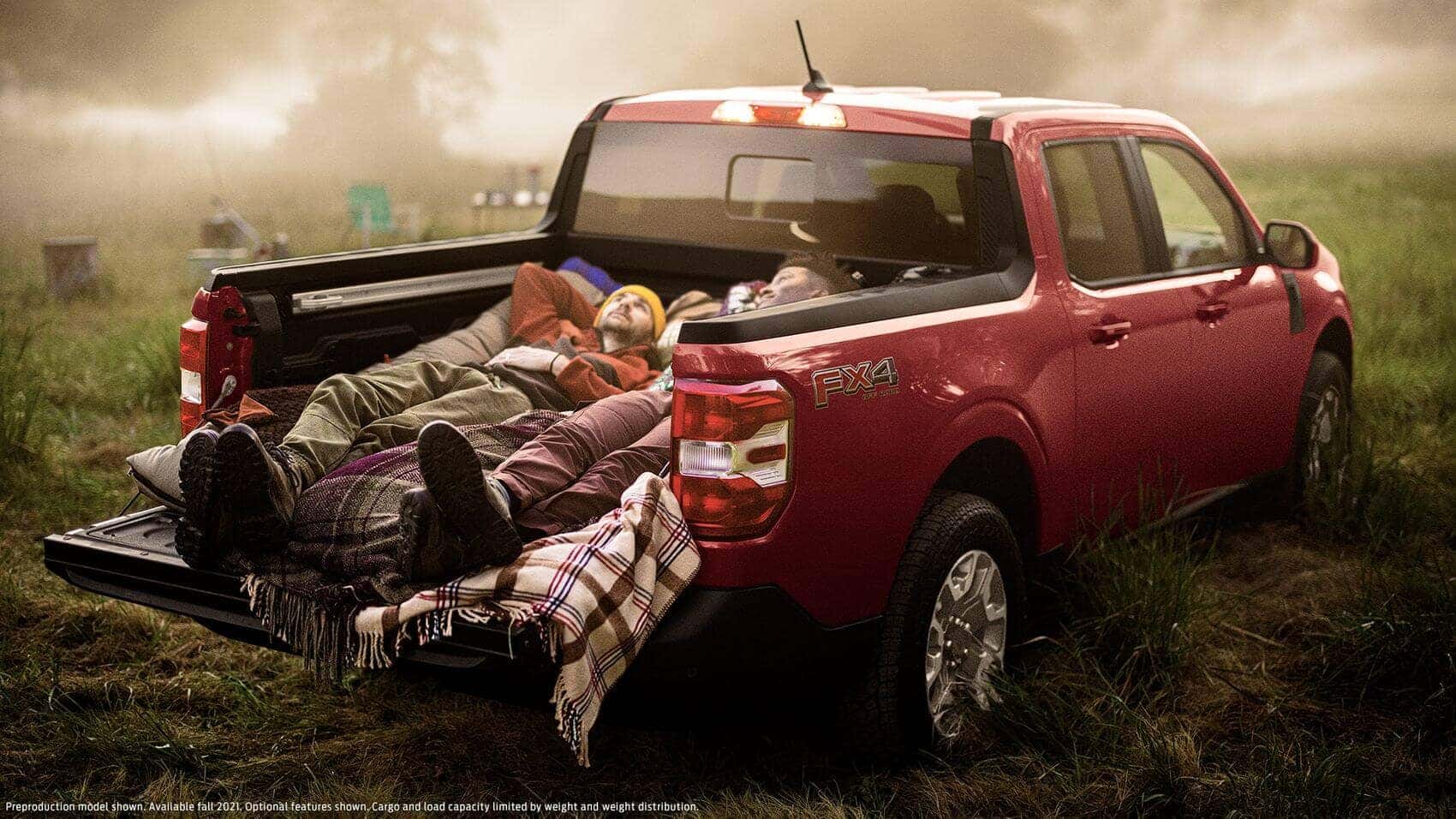 Campers relaxing in cargo box in Ford Maverick | Ira Ford Auburn | Auburn, MA
