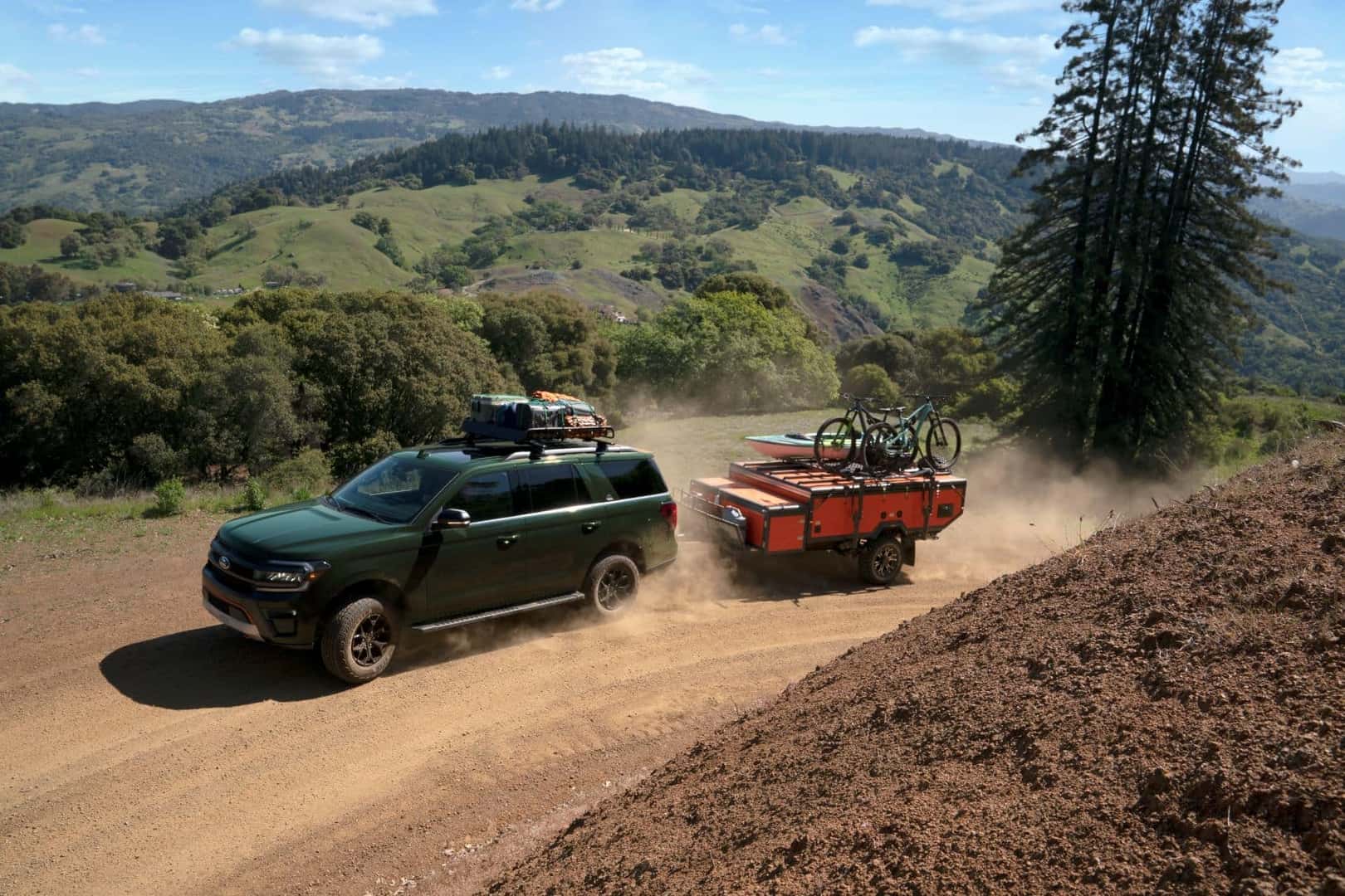 Ford Expedition driving on dirt road with large haul
