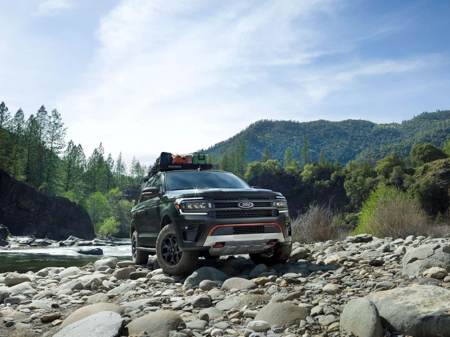 Ford Expedition driving on a rocky river bed
