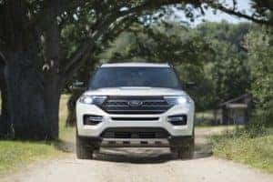 Ford Explorer SUV driving down dirt road