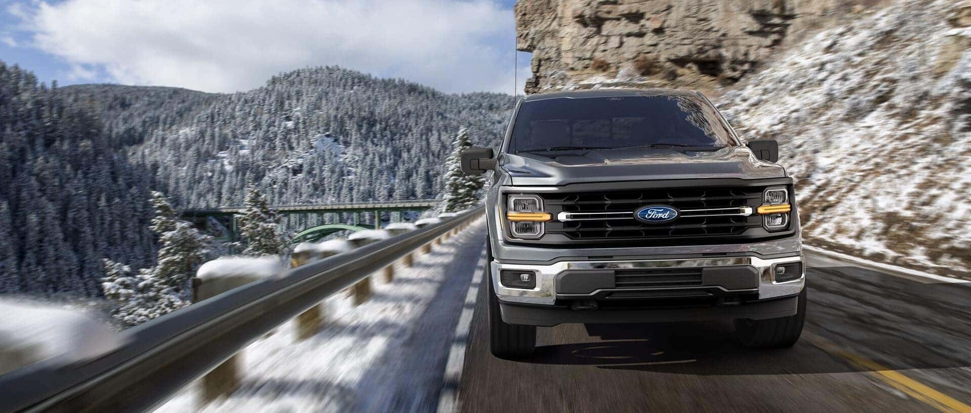 Red 2021 Ford Explorer driving up a hill out of a city
