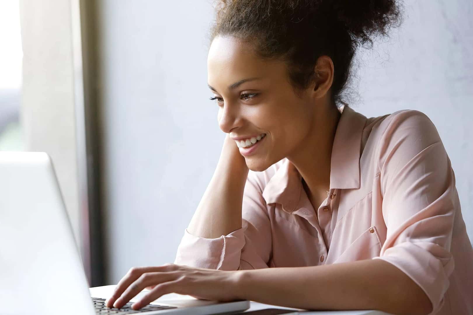 woman smiling at computer