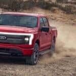 red ford f-150 pickup on dirt road