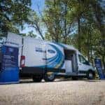 white ford e transit van with trees