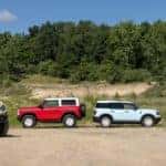 Yellow, Blue, Red, Ford Bronco SUVs Outside Trees