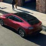 Red Ford Mustang Mach-E SUV Outside Two People