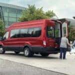 Red Ford Transit Van Family Gray Building
