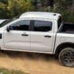 White Ford PickUp Off-Road Dirt Trail Trees