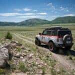 Mountains Blue Sky Multi-Color Ford Bronco SUV Rocks Dirt Road
