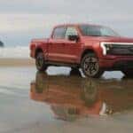 Red Ford F-150 Lightning EV Pickup Truck Sand Blue Sky