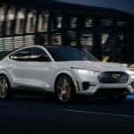 White Ford Mustang Mach-E EV SUV Building
