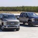 Gray and Black Ford F-250 Super Duty Pickup trucks trees and grass