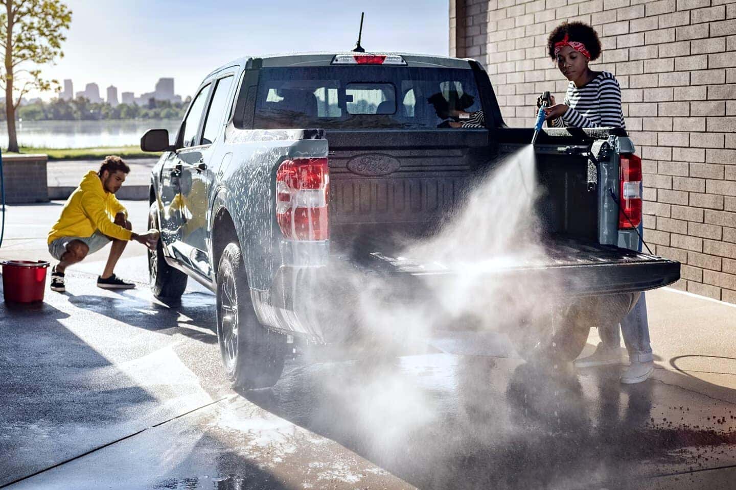 Gray Ford Maverick Pickup Truck Two People Water Hose Brick