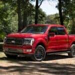 Red F-150 Pickup Truck Green Trees