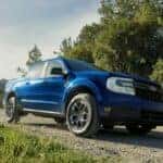 Blue Ford Maverick Compact Pickup Green Trees