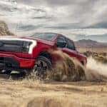 Red Ford F-150 Lightning EV Pickup Truck Sand Blue Sky