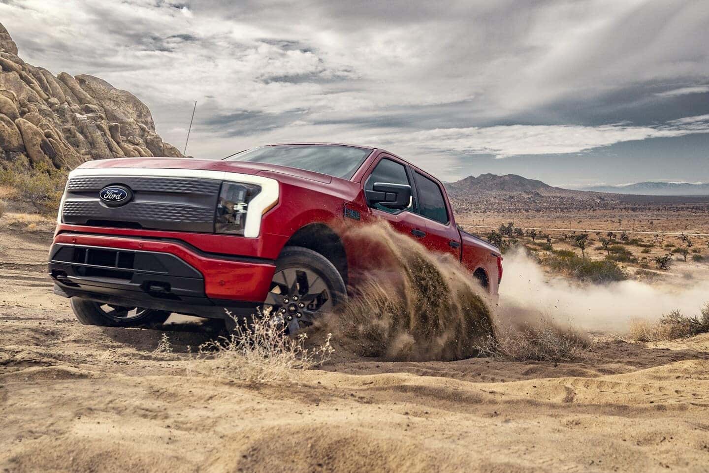 Red Ford F-150 Lightning EV Pickup Truck Sand Blue Sky