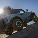 Blue Ford Bronco SUV Brown Hill Mountain Sun
