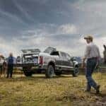 Silver Ford Super Duty Pickup Truck People Green Grass