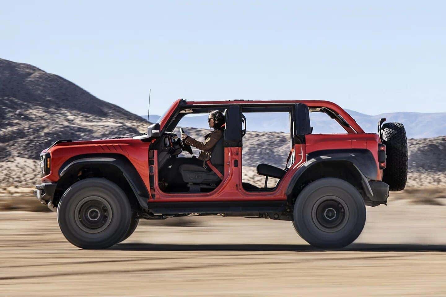 Red Ford Bronco SUV Woman Outside Dirt