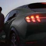 Green Ford Mustang Mach-E SUV Person