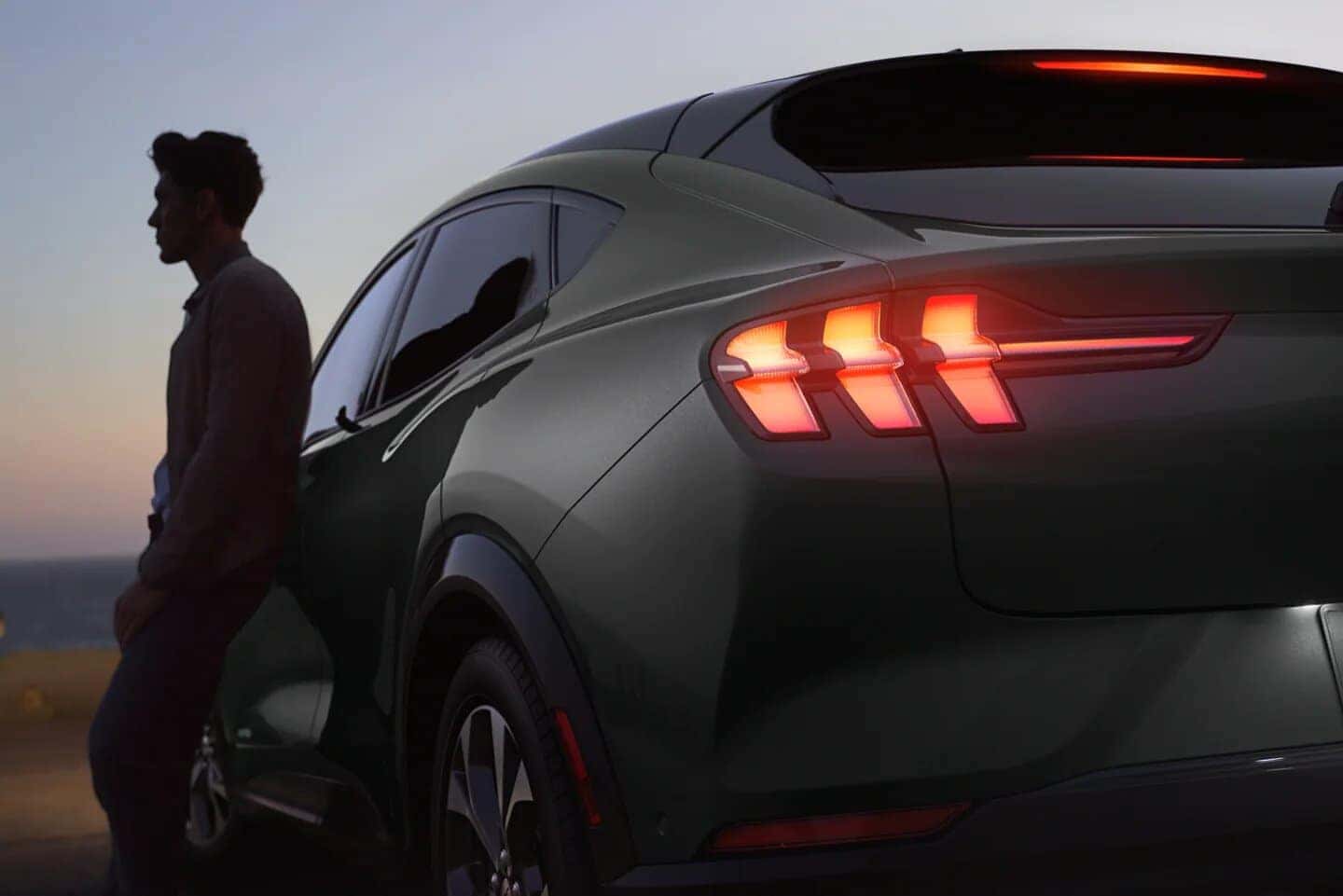 Green Ford Mustang Mach-E SUV Person