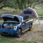 Blue Ford F-150 Lightning Pickup Tent Luggage Grass
