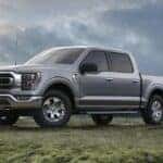 Gray Ford F-150 Pickup Green Grass Water Sky