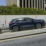 Blue Ford Edge SUV Outside Buildings Bushes