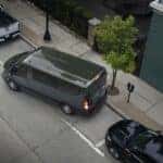 Gray Ford Transit Van White Pickup Black Sedan Street Tree