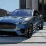 Blue Ford Mustang Mach-E SUV Outside House