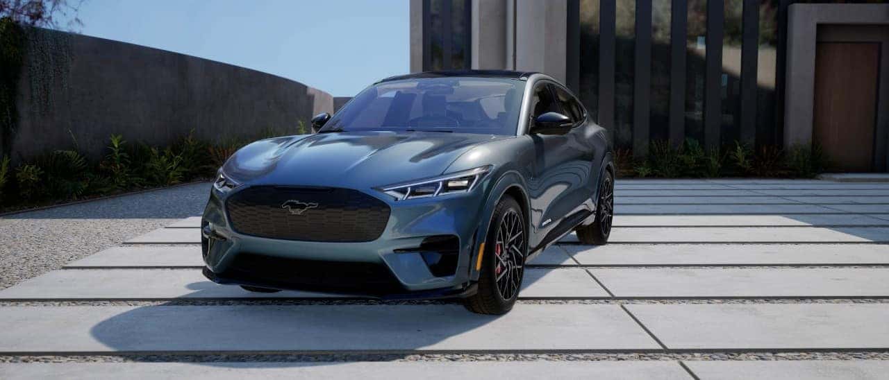 Blue Ford Mustang Mach-E SUV Outside House