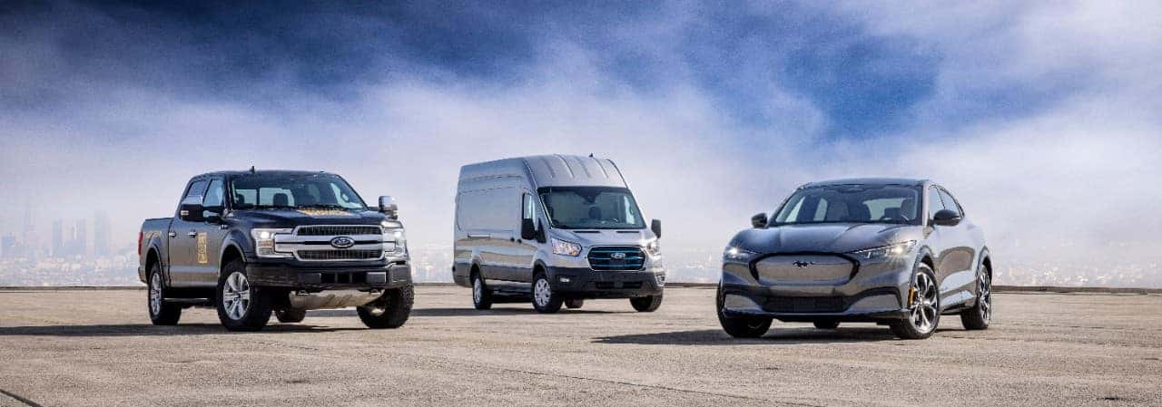 Black Ford F-150 Lighting Truck Gray Ford Transit Van Gray Ford Mustang Mach-E SUV EV Blue Sky