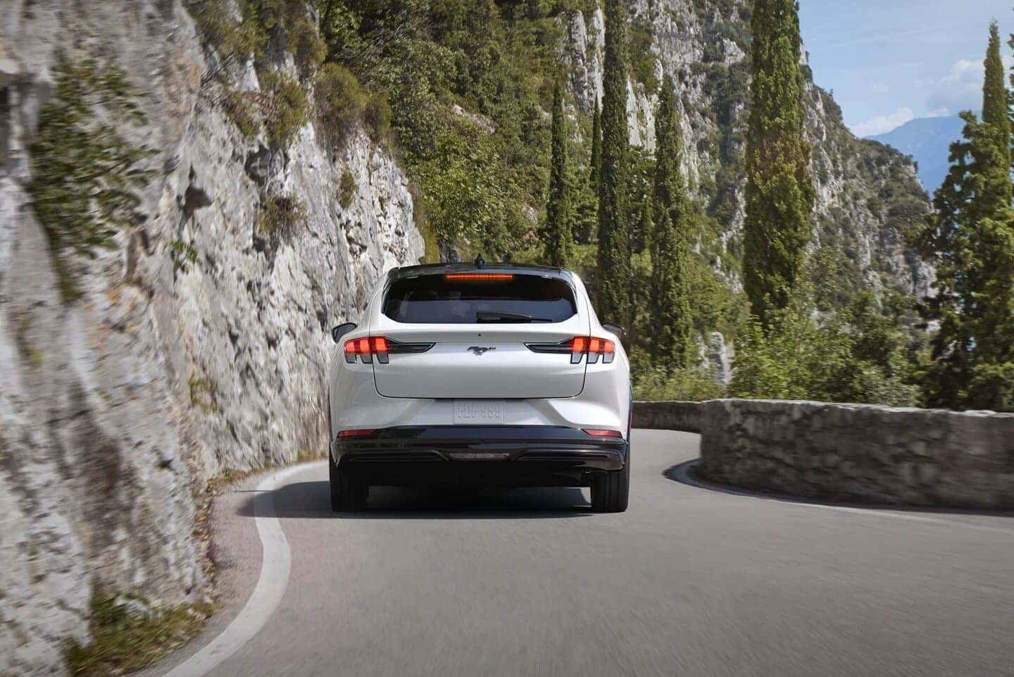 White Ford Mustang Mach-E EV SUV Mountains Open Road