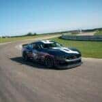 Blue Ford Mustang Sports Car Race Track Green Grass Blue Sky