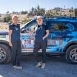 red,white, blue ford bronco sport SUV two women green trees