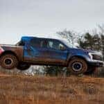 Blue Ford F-150 Lightning EV Truck Red Dirt Trees